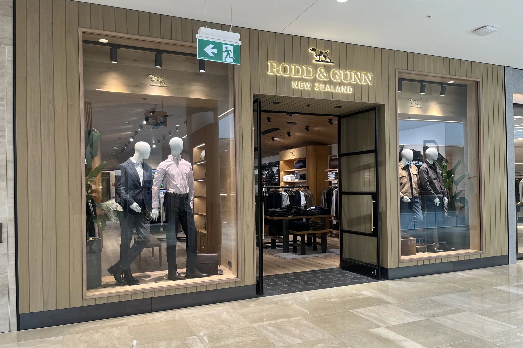 Shopfront glazing installed alongside timber-clad entry detailing