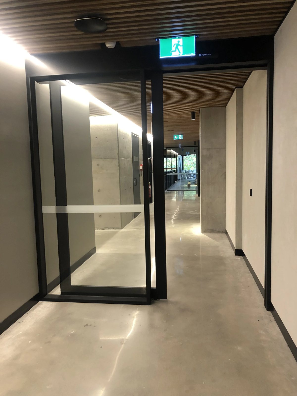 Glazed office partitions forming a corridor inside a commercial fit-out